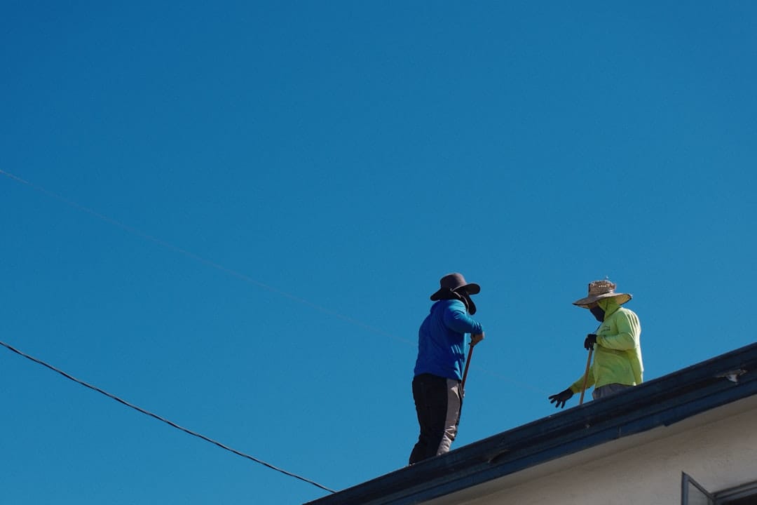 Roof repair specialists working on residential roof